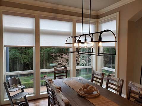 Rustic dining room with hanging shades